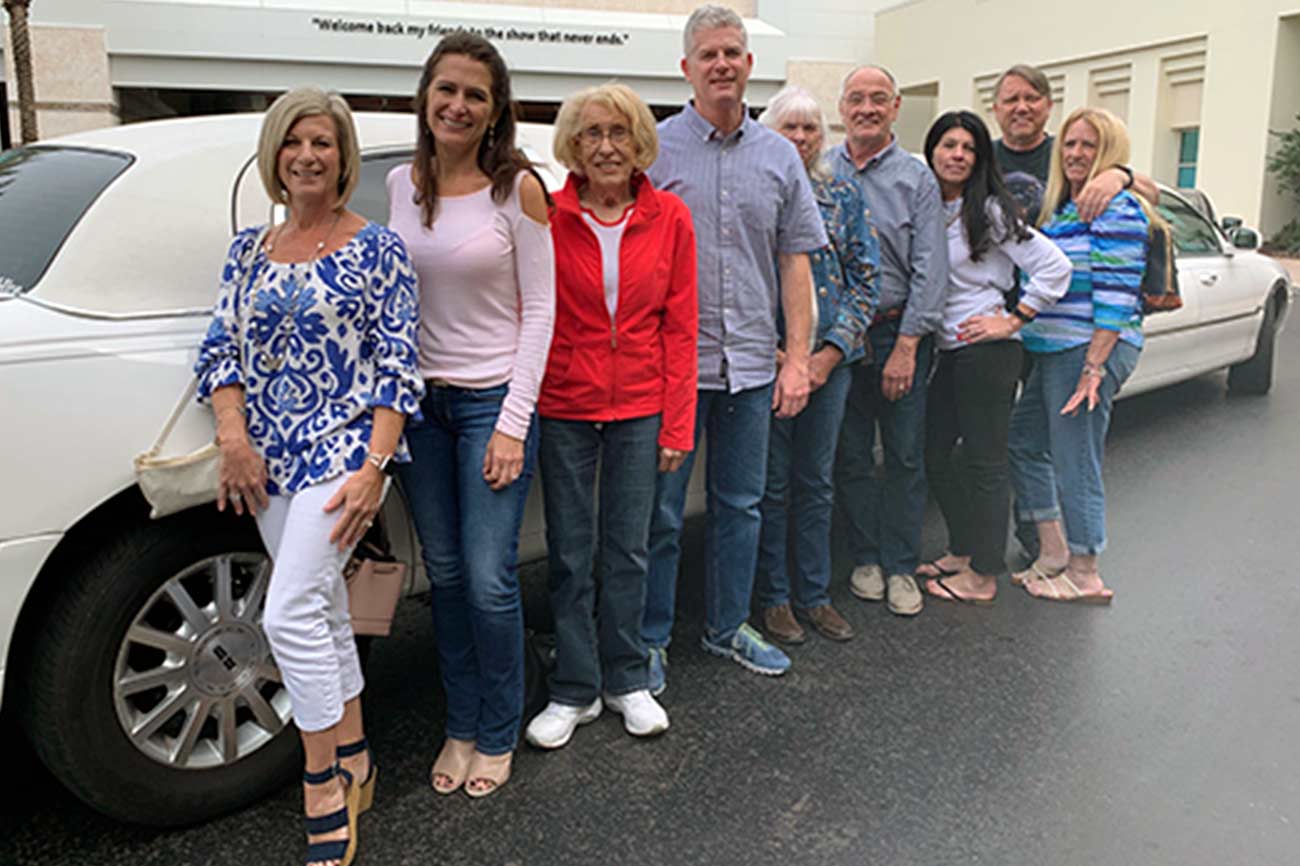 Blue Skye Lending team standing in front of white car