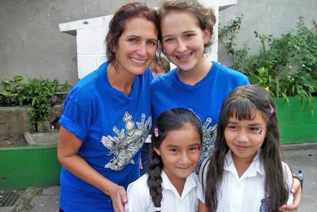 Mom and daughter standing with children.