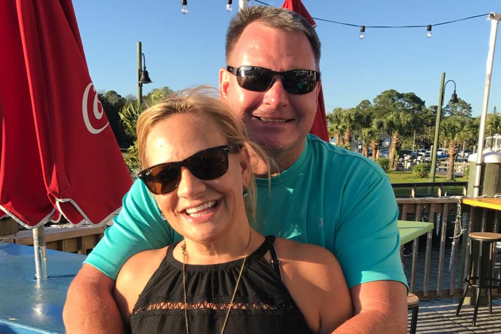 Pam and her husband smiling for the camera