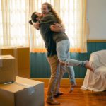 Man and woman hugging in new home