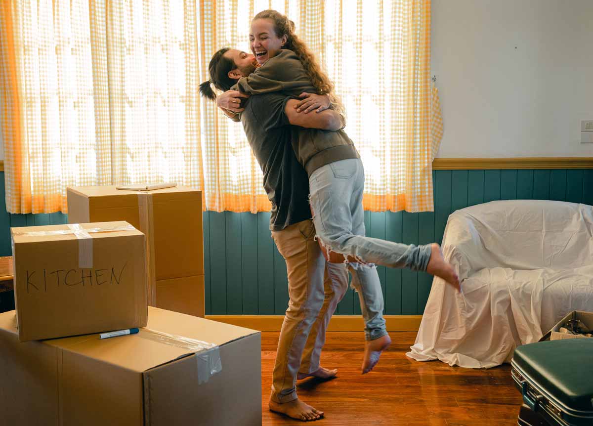 Man and woman hugging in new home