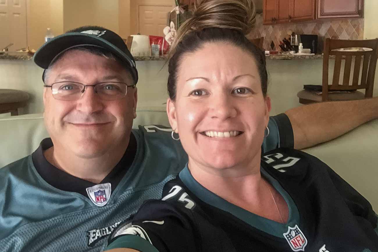 Tracie and her husband wearing NFL jerseys