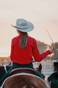 Cowgirl on a horse at a rodeo.